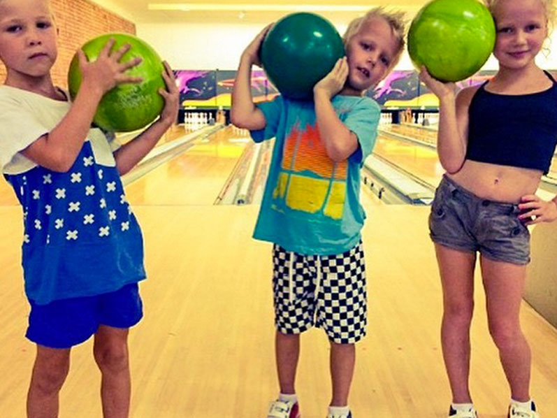 Three kids with bowling balls