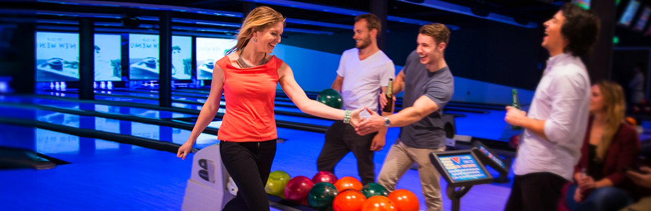 Young adults playing ten pin bowling